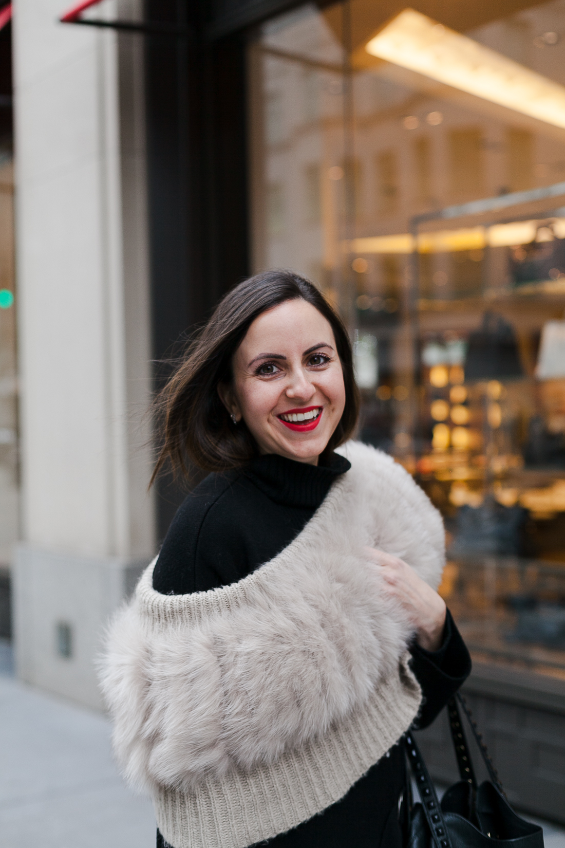 Yana Frigelis of NoMad Luxuries wearing an all black french-inspired look with a fur stole from mango