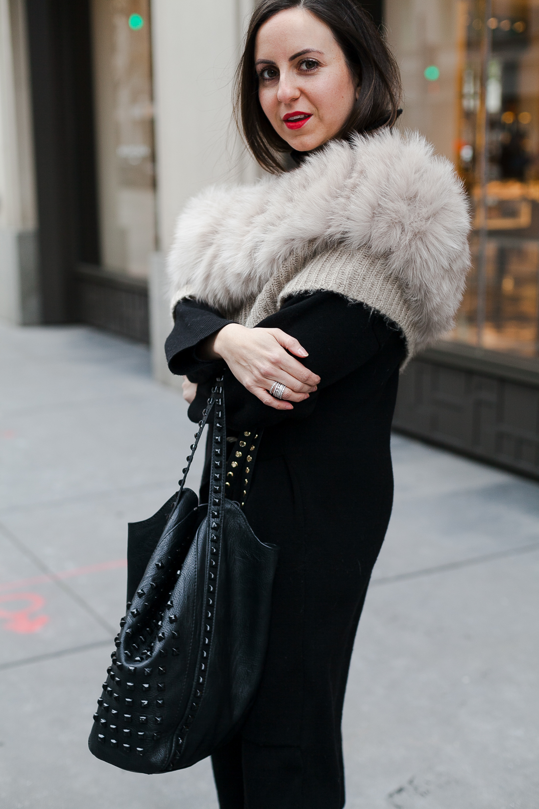 Yana Frigelis of NoMad Luxuries wearing an all black french-inspired look with a fur stole from mango