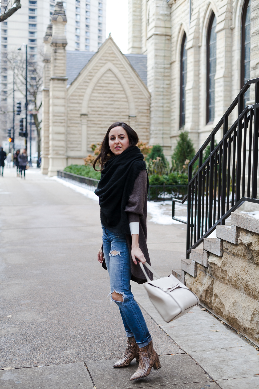 Yana Frigelis of NoMad Luxuries wearing a neutral look with ripped jeans and snake skin booties for Fall in Chicago