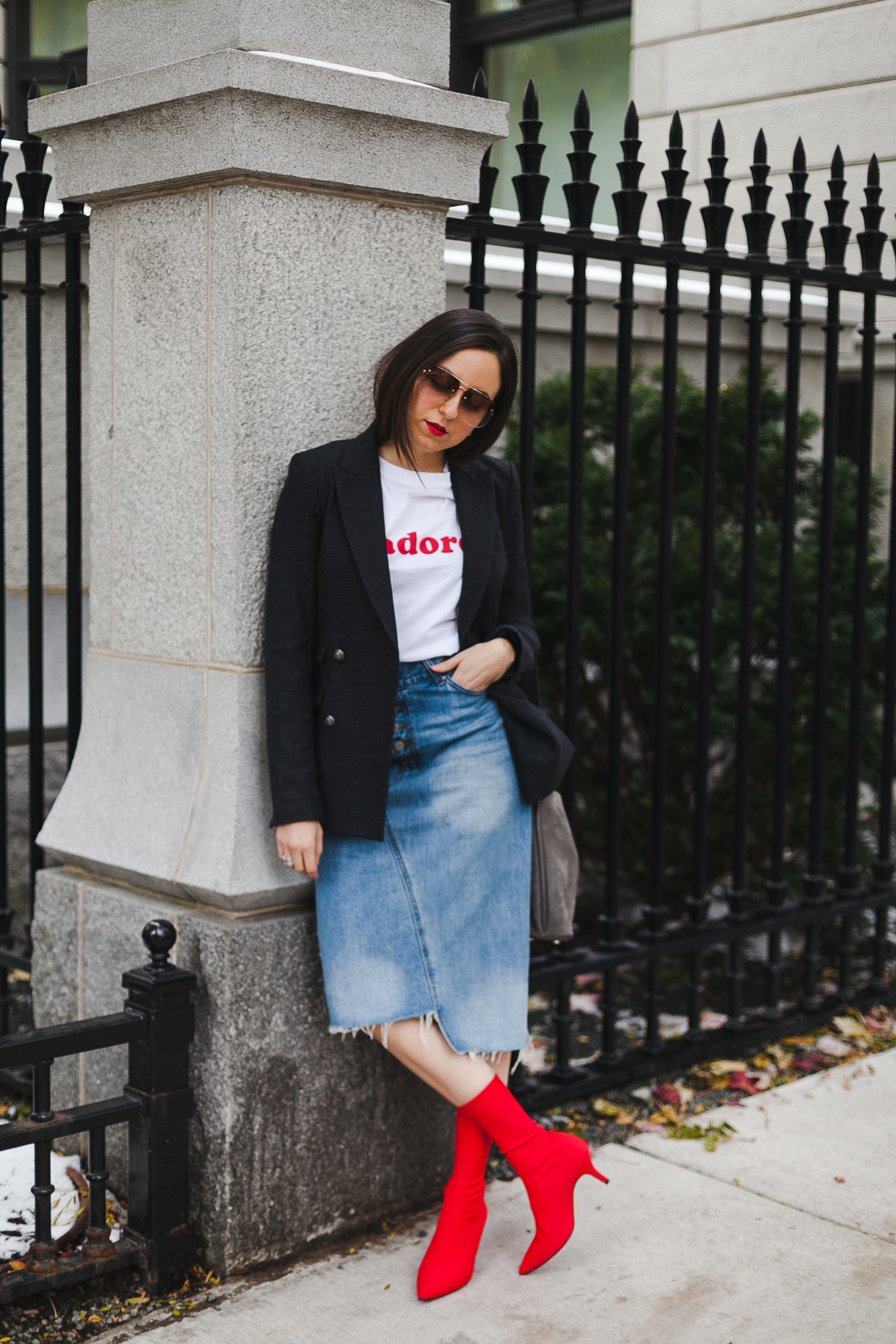 Yana Frigelis of NoMad Luxuries wearing a graphic tee under a blazer with red sock boots and a jean retro skirt for Fall