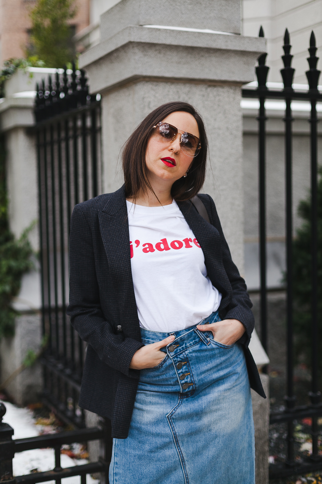 Yana Frigelis of NoMad Luxuries wearing a graphic tee under a blazer with red sock boots and a jean retro skirt for Fall