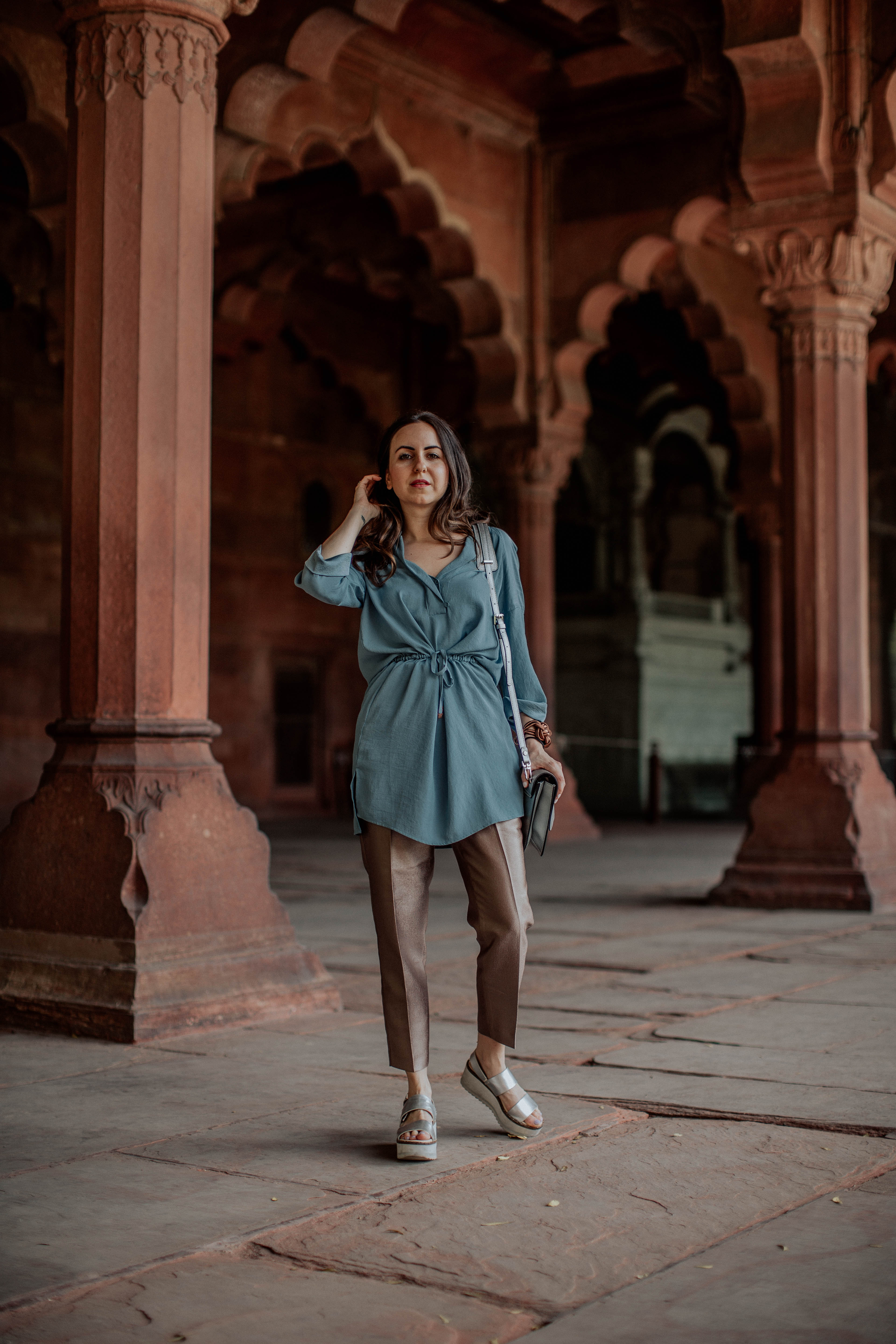 Yana Frigelis of NoMad Luxuries wearing metallic pants and a tunic in India and the lessons she learned traveling solo