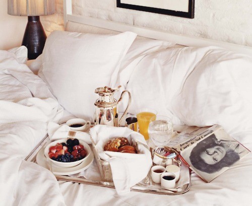 Nomad Luxuries photo displaying a sunny day with breakfast in bed. 