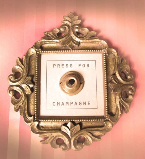 Nomad Luxuries photo of comical champagne button to celebrate the weekend. 