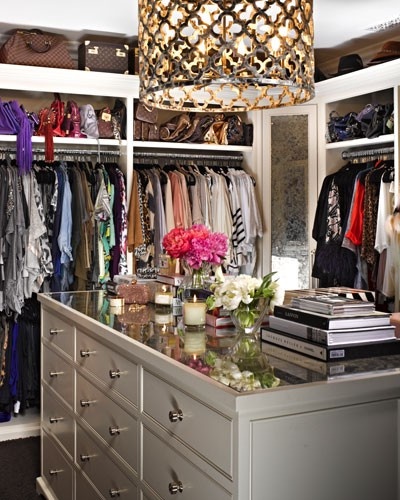 Nomad Luxuries photo for closet inspiration with a chandelier in the closet. 