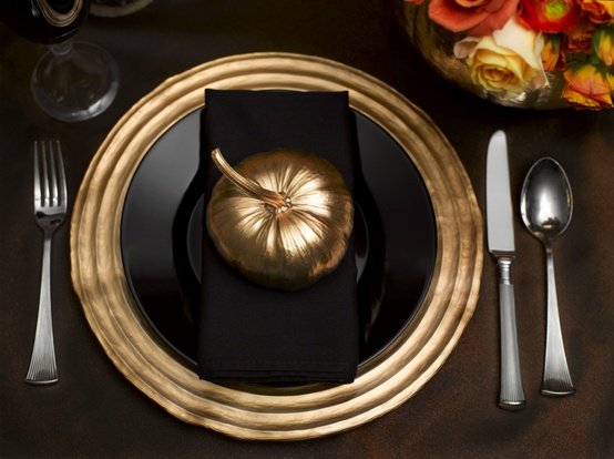 Nomad Luxuries painted gold pumpkin served on a platter. 
