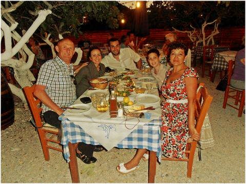 Nomad Luxuries photo captured of family dinner at a seafood restaurant in Santorini. 