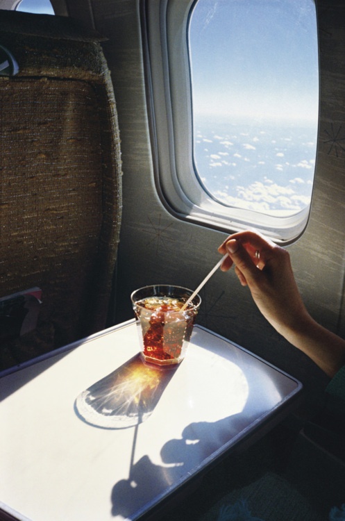 Nomad Luxuries; enjoying a cocktail mid air throughout a flight. 