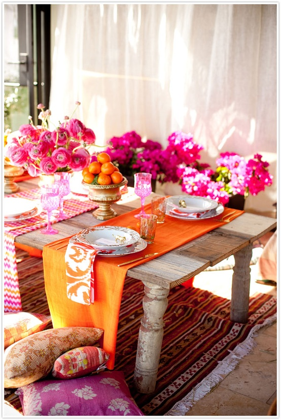 A Moroccan inspired styled table set with brightly colored trimming and table runners. 