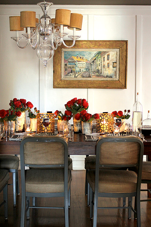 Nomad Luxuries; full photo of rustic black and white dining table with red accents. 