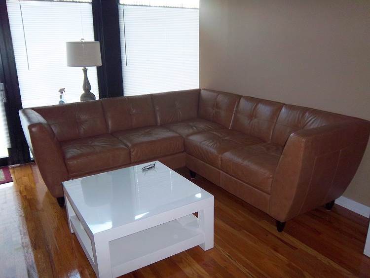 Home of Yana Frigelis of Nomad Luxuries featuring a cognac brown leather couch for sale. 