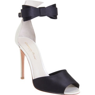 Nomad Luxuries photo of tuxedo inspired high heels with bow detailing.