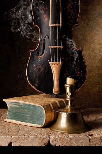 Nomad Luxuries photo of vintage violin and book. 